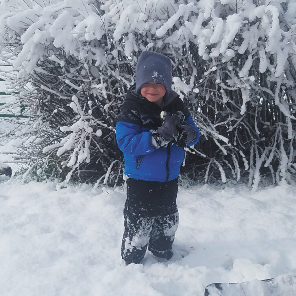 Karson sledding in fresh snow copy